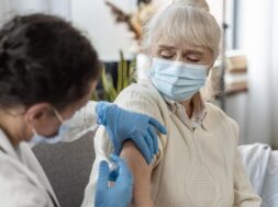 doctor-vaccinating-senior-woman_23-2148962364