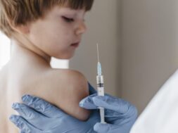 doctor-with-gloves-performing-vaccine-little-child_23-2148801365