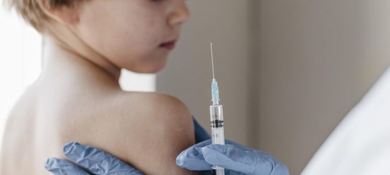 doctor-with-gloves-performing-vaccine-little-child_23-2148801365