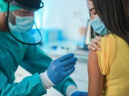 doctor-with-hazmat-suit-protective-gloves-giving-patient-vaccine-coronavirus-disease-focus-doctor-hand_166273-1005