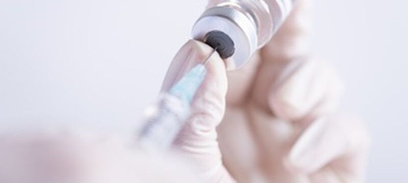 female-doctor-hands-holding-syringe-vaccine_53476-4959