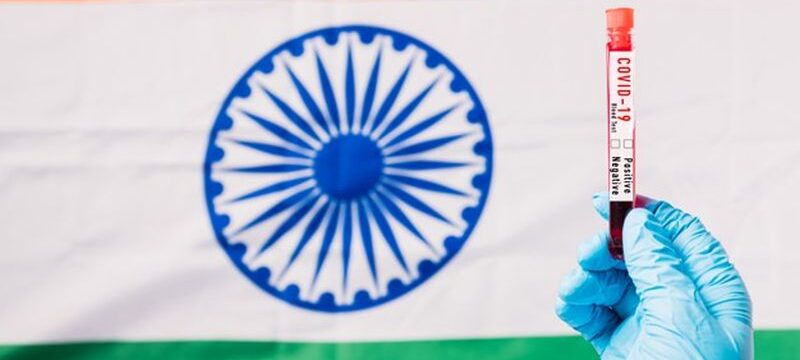 hands-doctor-wearing-gloves-holding-blood-test-tube-coronavirus-covid-19-virus-laboratory-flag-india_143683-1216