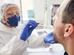 mature-man-opening-mouth-while-doctor-protective-clothing-examining-his-throat-during-medical-exam-hospital_249974-2969