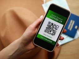 new-normal-concept-close-up-view-female-s-hold-smartphone-with-immune-digital-health-passport_320760-488