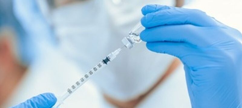 scientist-filling-syringe-with-new-vaccine_160672-5886