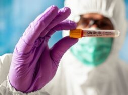 scientist-wearing-respirator-mask-holding-positive-blood-test-result-new-rapidly-spreading-coronavirus_179314-37