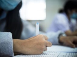 students-wearing-mask-protect-covid-19-doing-exam-classroom-with-stress_73622-2038