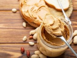 toast-sandwich-with-peanut-butter-spoon-jar-peanut-butter-peanuts-cooking-breakfast_221542-627