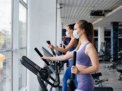 two-young-beautiful-girls-exercise-gym-wearing-masks-during-pandemic_180601-9453