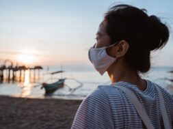 woman-visiting-beach-with-face-mask-healthy-sunny-morning_8595-19670