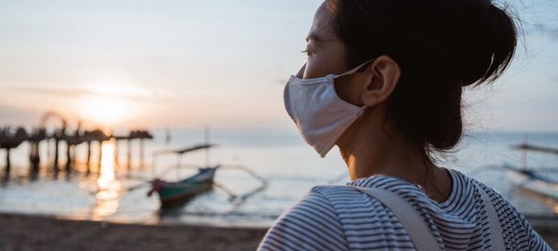 woman-visiting-beach-with-face-mask-healthy-sunny-morning_8595-19670