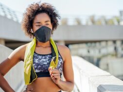 afro-athletic-woman-wearing-face-mask-relaxing-after-work-out-outdoors-street_58466-14593