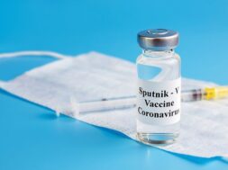 ampoule-with-vaccine-against-virus-with-medical-mask-insulin-syringe_262398-438