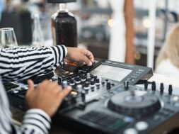 black-dj-playing-music-cocktail-bar-outdoor-while-wearing-face-safety-mask-entertainment-social-distance-party-concept-focus-left-hand_166273-1414