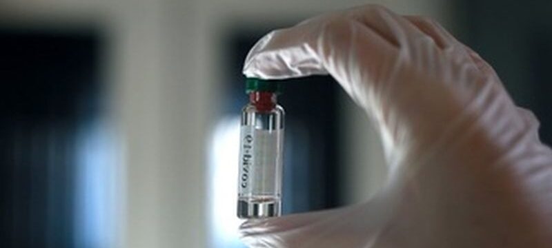 close-up-fingers-hand-medical-glove-hold-glass-bottle-medicine_254554-119