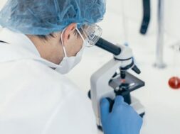 close-up-scientist-looking-through-microscope-photo-with-copy-space_160672-3569