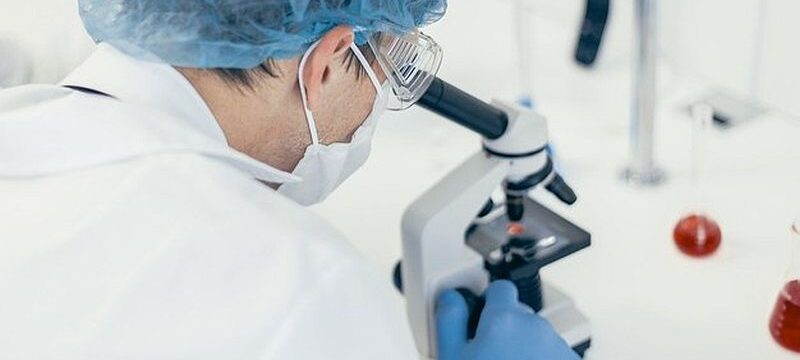 close-up-scientist-looking-through-microscope-photo-with-copy-space_160672-3569