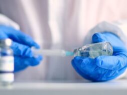 doctor-blue-latex-gloves-fill-syringe-with-medicine-from-glass-vial-injection-elderly-person-medical-laboratory-against-coronavirus-flu-measles-disease_68196-4732