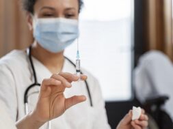 doctor-preparing-vaccine-senior-woman_23-2148962306