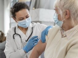 doctor-vaccinating-senior-woman_23-2148962365