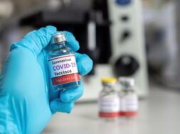 hand-wearing-medical-gloves-hold-vials-covid-19-coronavirus-vaccine-laboratory-syringes-tubes-medical-science_51903-350