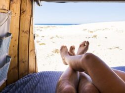 legs-point-view-romantic-couple-inside-old-van-enjoying-beach-ocean-parking-together_425263-1625