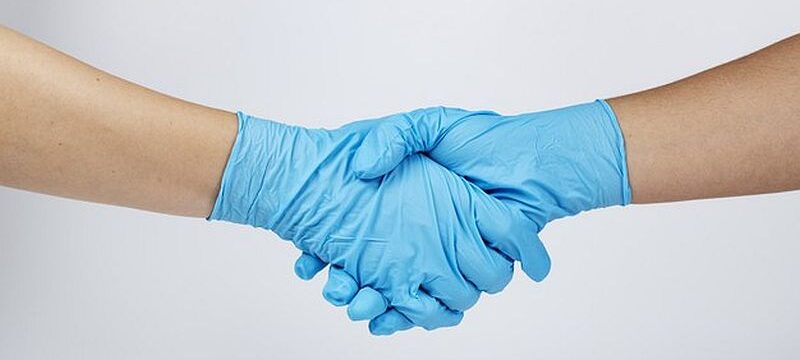 medical-staff-shaking-hands-during-coronavirus-pandemic_53876-95283