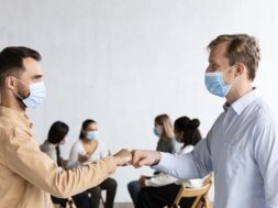 men-with-medical-masks-fist-bumping-each-other-group-therapy-session_23-2148752118