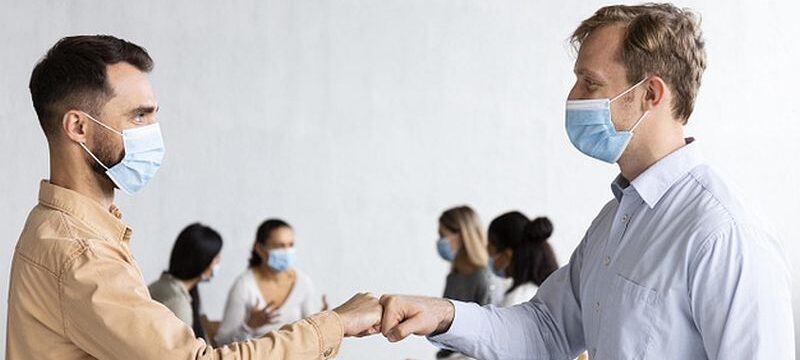 men-with-medical-masks-fist-bumping-each-other-group-therapy-session_23-2148752118