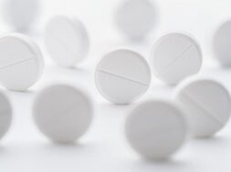 pile-white-pills-scattered-bright-white-background-selective-focus-mockup-layout-template_76263-2242