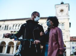 portrait-black-ethnic-couple-with-protective-mask-bicycle_187712-261