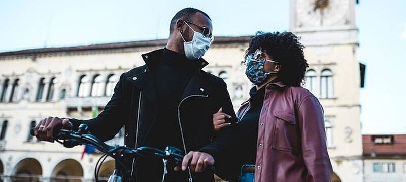 portrait-black-ethnic-couple-with-protective-mask-bicycle_187712-261