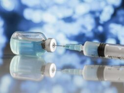 syringe-vaccine-bottle-table_23-2148801430