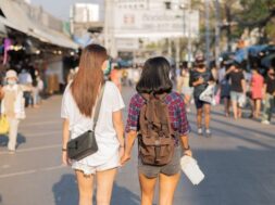 two-women-travelling-together-busy-street_1150-42469
