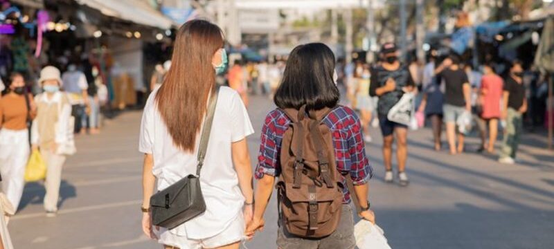 two-women-travelling-together-busy-street_1150-42469