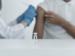 vaccine-table-doctor-holding-syringe-was-about-vaccinate-patient-clinic-prevent-spread-virus_177530-447