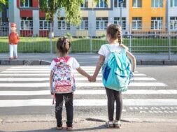 back-school-education-concept-with-girl-kids-elementary-students-carrying-backpacks-going-class_169016-6127