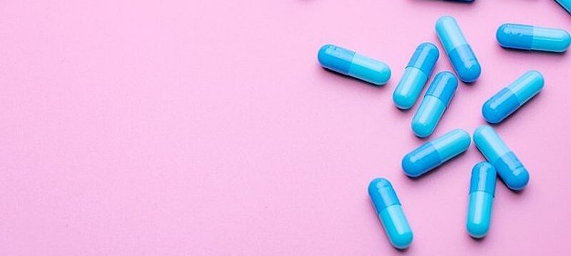 blue-capsule-pills-pink-background-with-copy-space_33867-1782