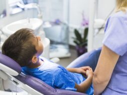 child-patient-leaning-dental-chair-clinic_23-2147906075