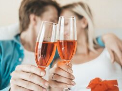happy-couple-drinking-wine-bedroom_1150-12109
