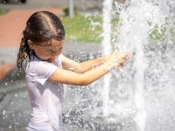 happy-little-girl-among-splashing-water-city-fountain-has-fun-escapes-from-heat_169016-12597