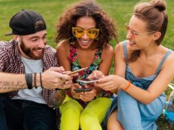 happy-young-company-smiling-friends-sitting-park-using-smartphones-man-women-having-fun-together_285396-8722 (3)