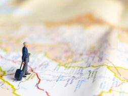 miniature-business-people-standing-map-travel-concept_29654-725