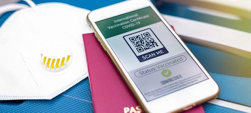 passport-smartphone-with-international-vaccination-certificate-covid-19-qr-code-suitcase-with-mask_1268-17840