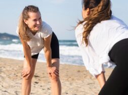two-women-exercising-together-beach_23-2148694872