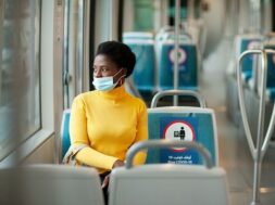young-african-woman-wearing-protective-mask-rides-bus-looks-out-window-coronavirus-social-distance_110194-1734
