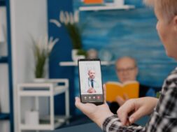 Middle aged woman talking at video conference calling with remote doctor