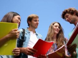 students-standing-outside-chatting-on-college-campus