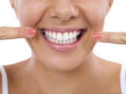 Woman showing her white teeth.