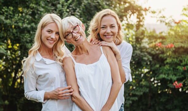 Three women enjoying outdoors, talking and laughing